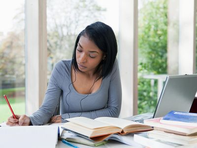 University student writing at desk