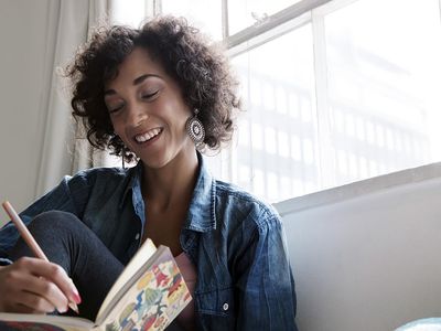 Smiling woman writing in journal