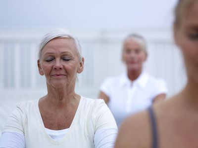 Three women doing pilates on wooden terrace