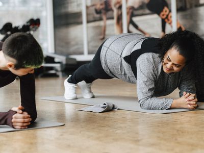 People practicing plank position in gym