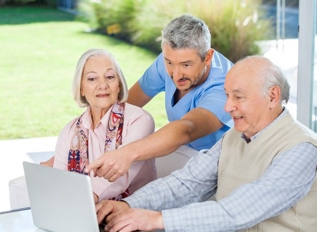 Man assisting with computer