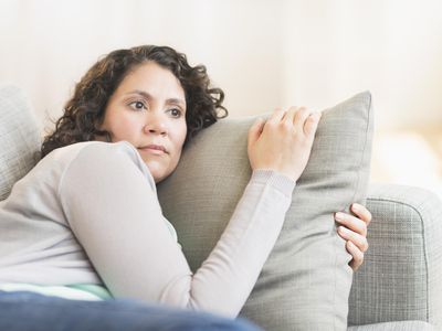 worried woman on sofa