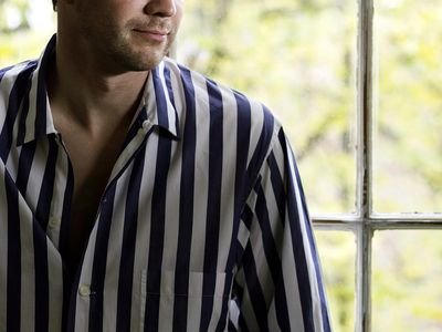 Man sitting by window in his pajamas