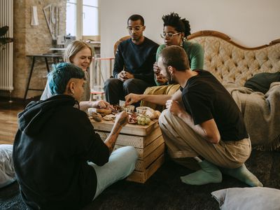 People having breakfast in living room 