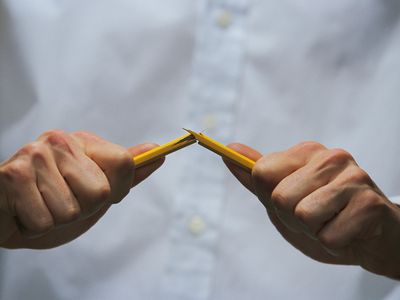 Hands snapping pencil