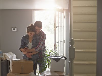 A couple hugging playfully in their new home