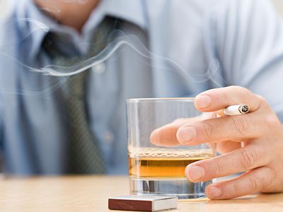 Man drinking whisky and smoking