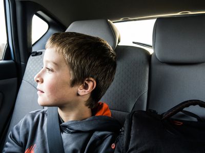 boy (10yrs) looking out car window