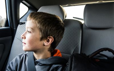 boy (10yrs) looking out car window