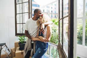 Young couple embraces in their apartment in Spain