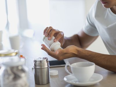 Close-up of a person taking a GABA supplement