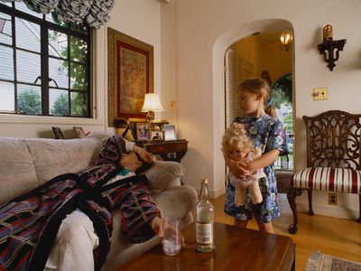 young Daughter Looking at drunk Mother on the couch