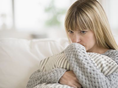 Sad woman sitting on sofa