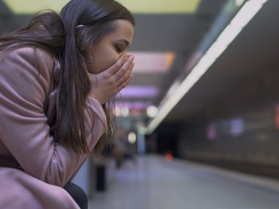 Desperate lady suffering anxiety attack at subway station, feeling helpless