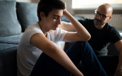 Upset young man talking with his father.