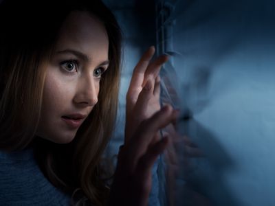 Woman looking out of the window at night