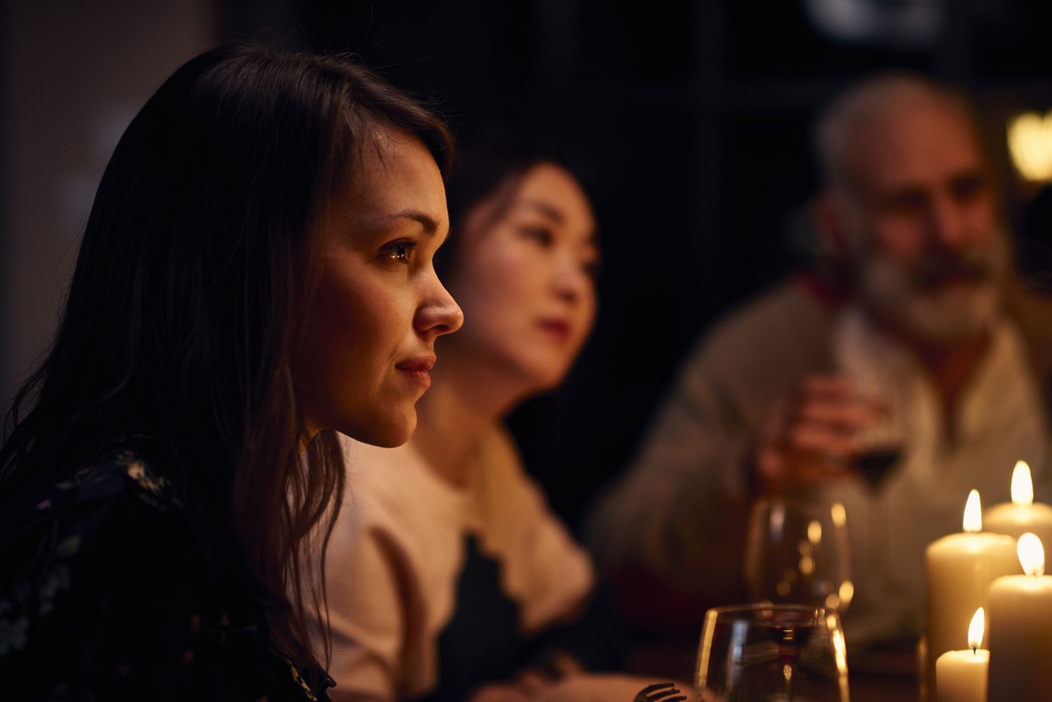 woman sitting quietly with friends at a restaurant