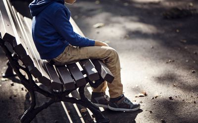 Sad boy sitting on bench