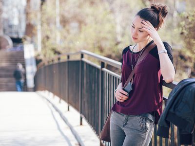 Unhappy woman standing outside