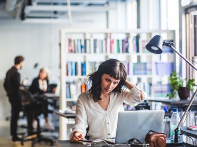 Businesswoman looking at laptop while sitting in office