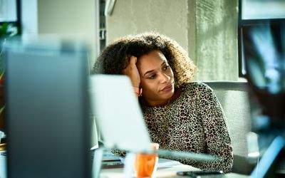 woman looking bored at desk