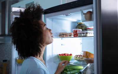 Woman Searching Food In Refrigerator