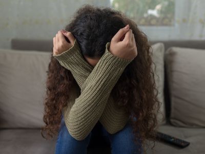 Unhappy girl on sofa