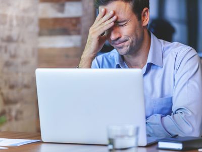 man looking stressed at computer