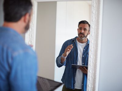 Cropped shot of an attractive mature man having a rehearsal in the mirror while holding a digital tablet