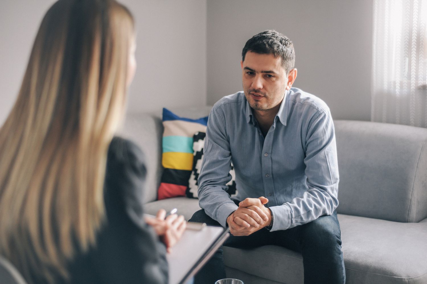 A photography of a man talking to his therapist.