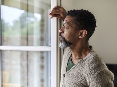 Man looking out window