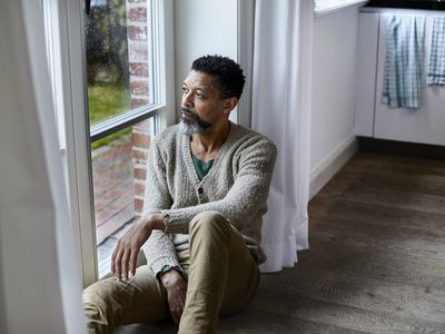 A man with depression gazing out of a window