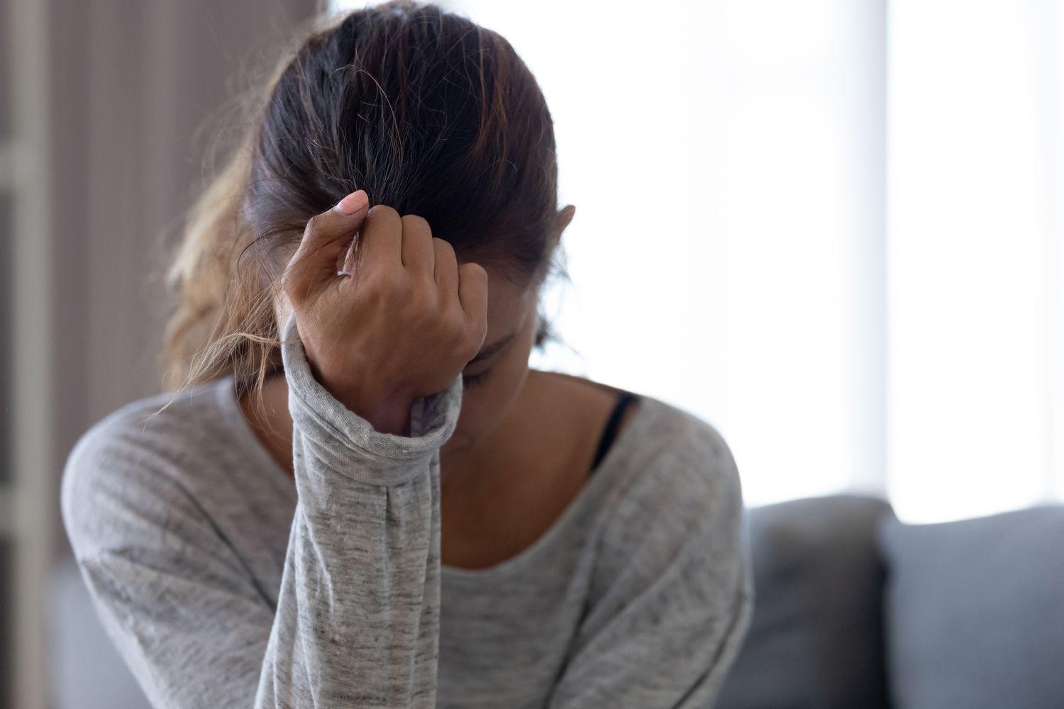 sad woman with head in one hand