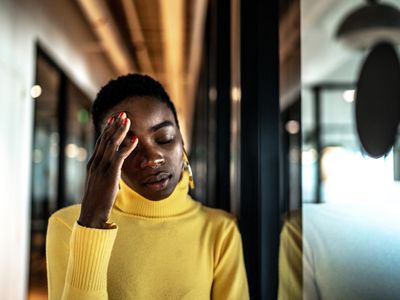 Worried young businesswoman at corridor office