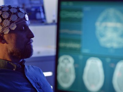 A man having an EEG to measure brain wave activity.