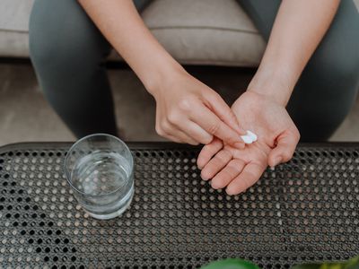 Young woman holding supplements