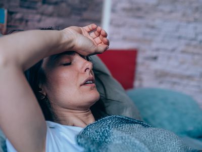 Sick woman lying in bed