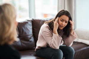 Shot of a young woman having a therapeutic session with a psychologist