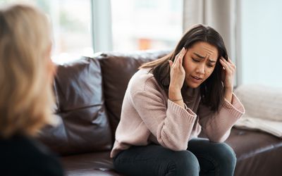 Shot of a young woman having a therapeutic session with a psychologist