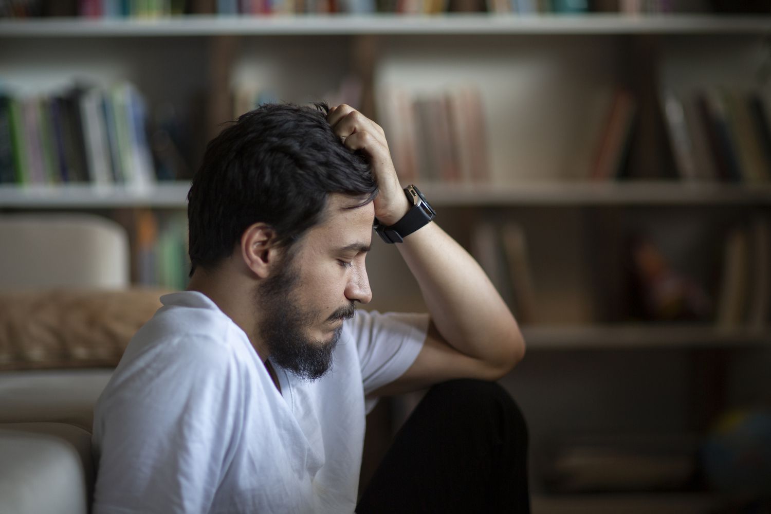 depressed man sitting in room