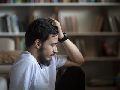 depressed man sitting in room