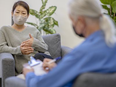 patient and therapist wearing masks in office