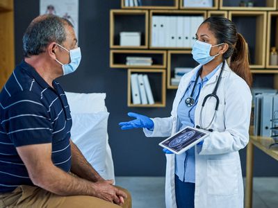 Shot of a doctor using a digital tablet to discuss a brain scan with a senior patient