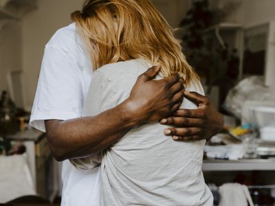 Son embracing mother in living room