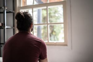 person looking out their window