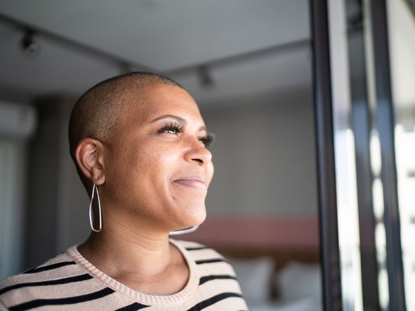 Woman with bipolar disorder looking out window.