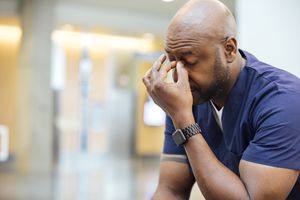 Tired male nurse resting in hospital