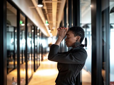 Worried young business woman at corridor office