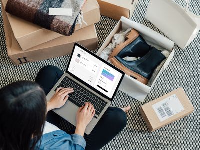 Overhead View Of Young Woman Doing Online Shopping With Laptop