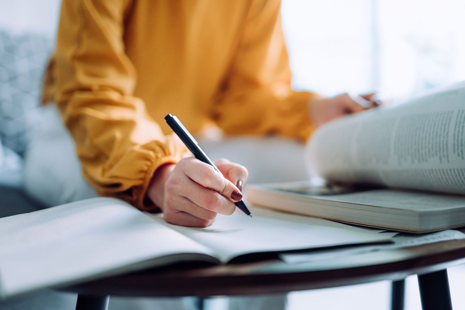 person reading and taking notes